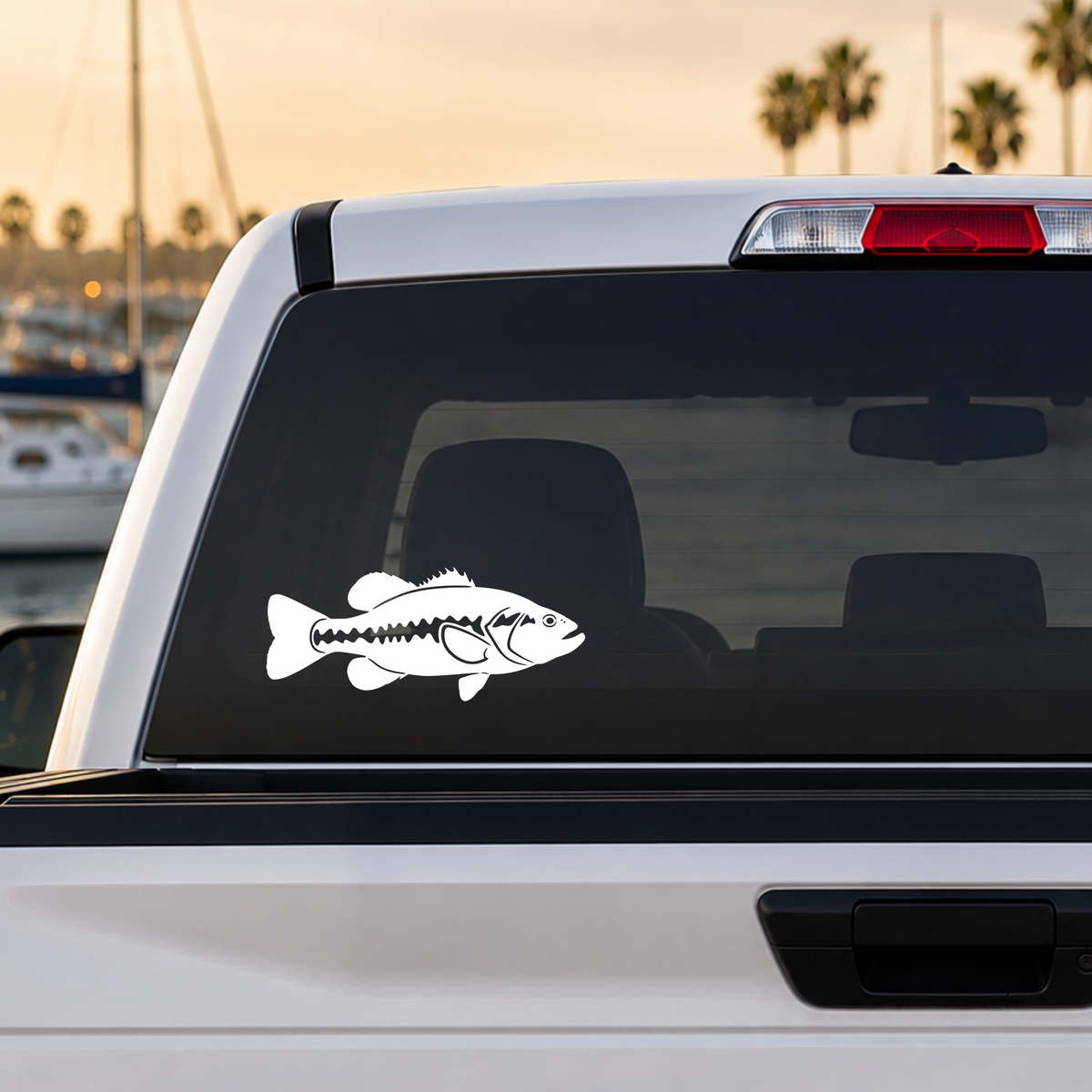 White Largemouth Bass vinyl decal featuring a detailed silhouette of the freshwater gamefish applied to the rear window of a truck. Original Keeper Designs freshwater fishing artwork. Made in the USA.